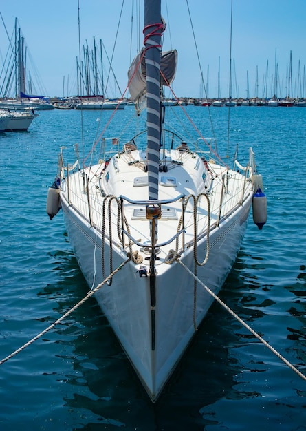 Yacht bianco su un molo legato con una corda