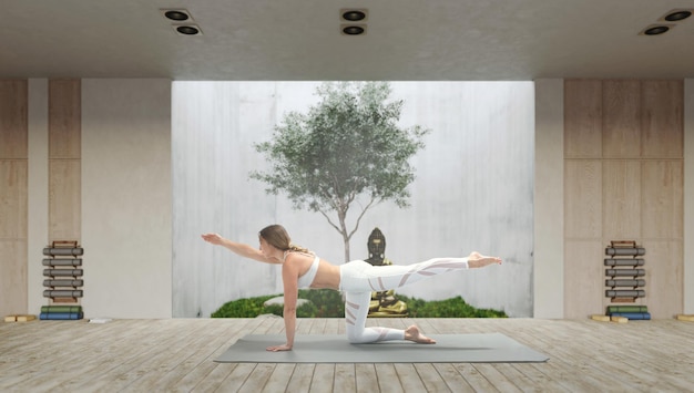 Yoga di pratica della giovane donna attraente atletica