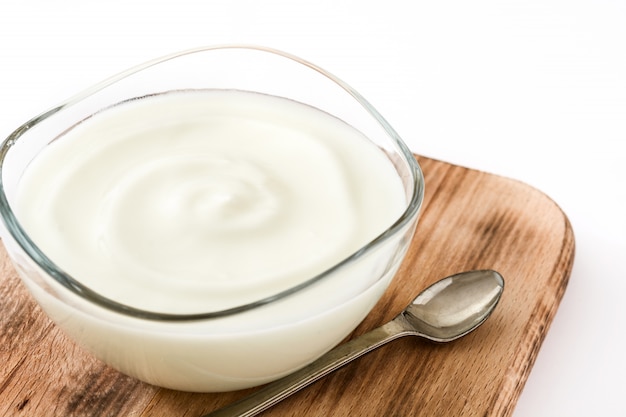 Yogurt greco in ciotola di vetro isolata su superficie bianca