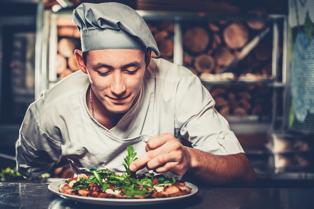 Young chef preparing traditional Italian pizza