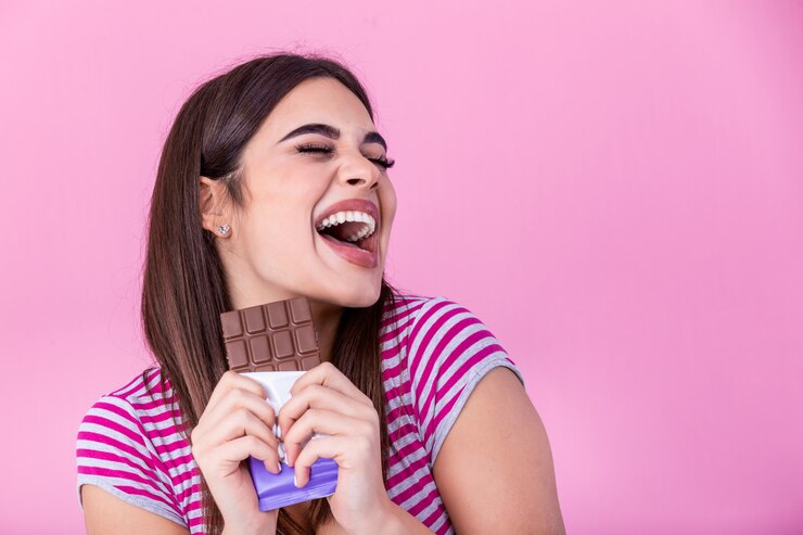 Young woman having fun and eating chocolate