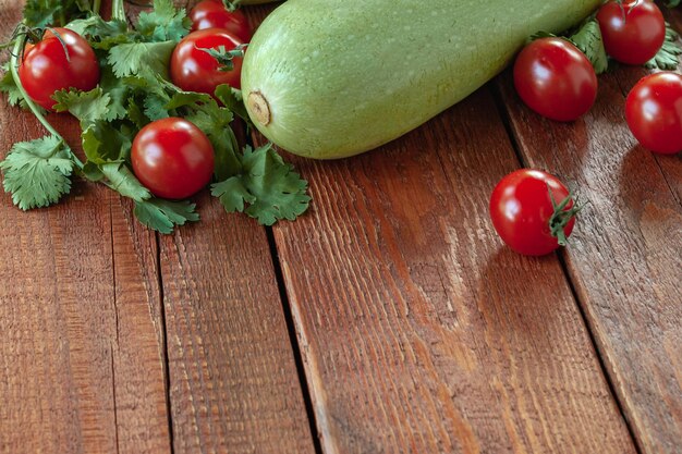 Zucchine e pomodori su fondo di legno