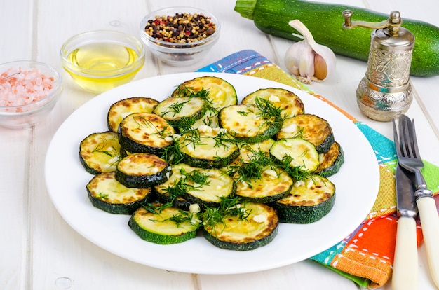 Zucchine grigliate con aglio ed erbe. Foto