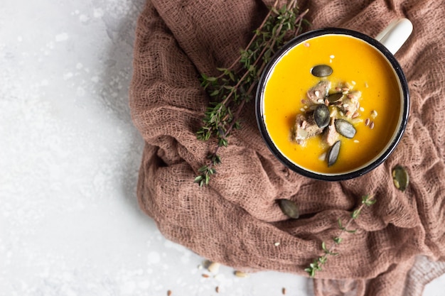 Zuppa cremosa di zucca servita con fegato e semi