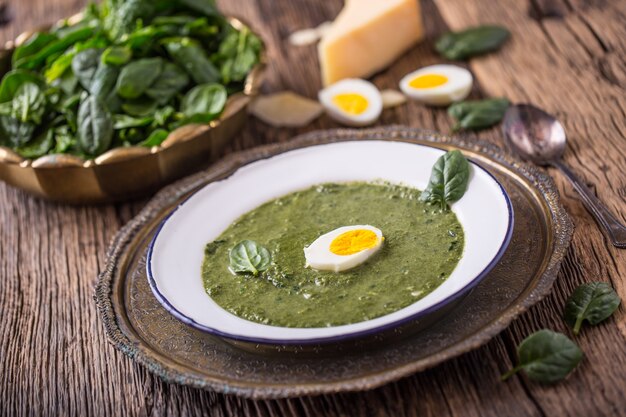 Zuppa di spinaci. Zuppa di spinaci con uova e parmigiano in stile retrò.