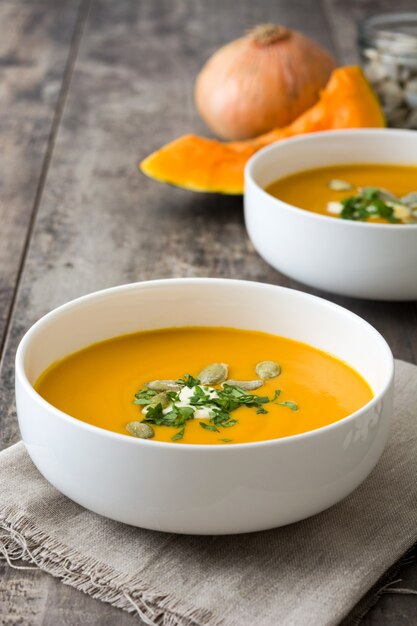 Zuppa di zucca in una ciotola sul tavolo di legno