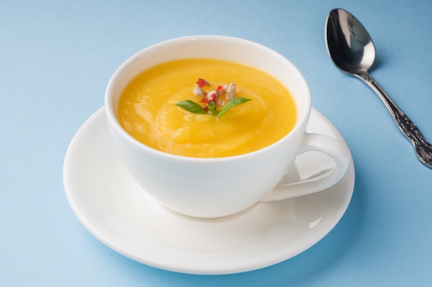 Zuppa di zucca schiacciata con spezie in una tazza.