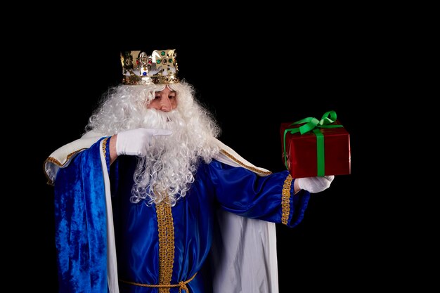 a magician king with a present on a black background