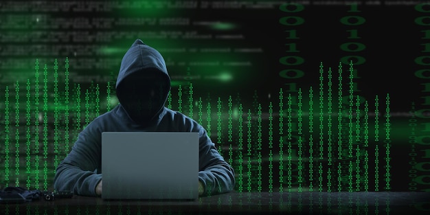 A masked hooded hacker panorama uses a laptop background with a binary character code Hacking and malware concept