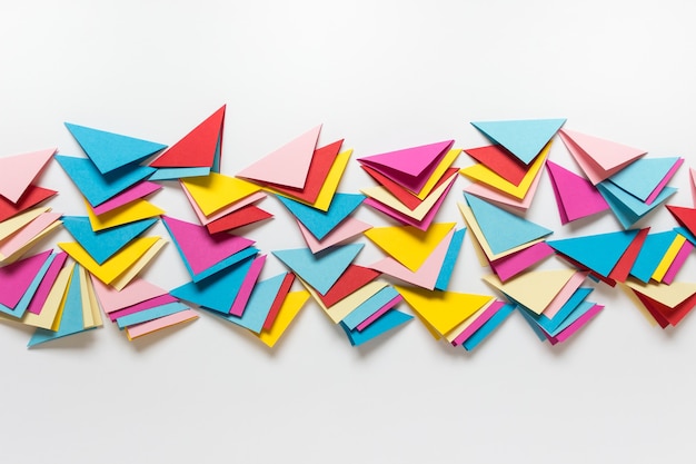 abstract background with many folded paper triangles at image center and blank space.