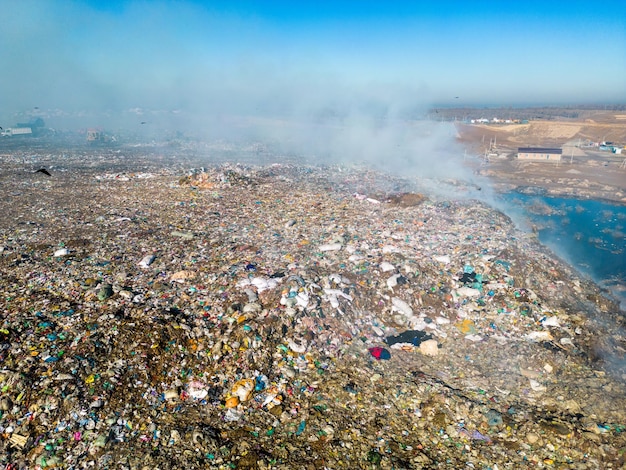 Aerial view of burning trash piles in landfill
