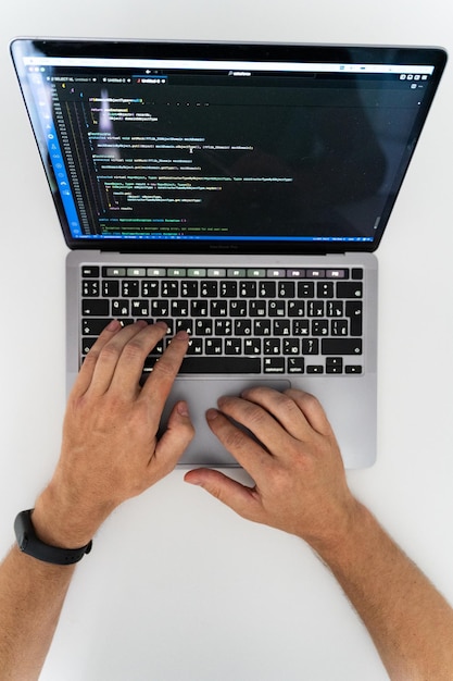 An overhead view of the hands of a man working at a computer