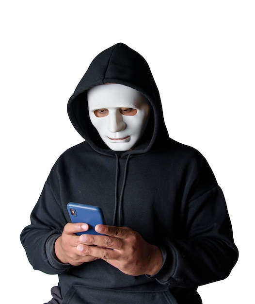 anonymous masked hacker is using smartphones to penetrate financial data with clipping path hacking and malware concept