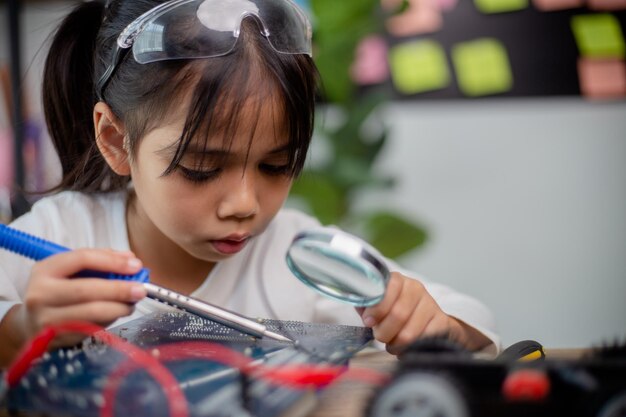 Asia students learn at home in coding robot cars and electronic board cables in STEM STEAM