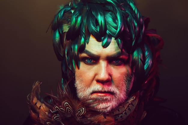 bearded old man in feather hat