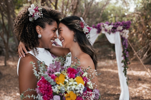 Beautiful lesbian couple celebrating their wedding day outdoors