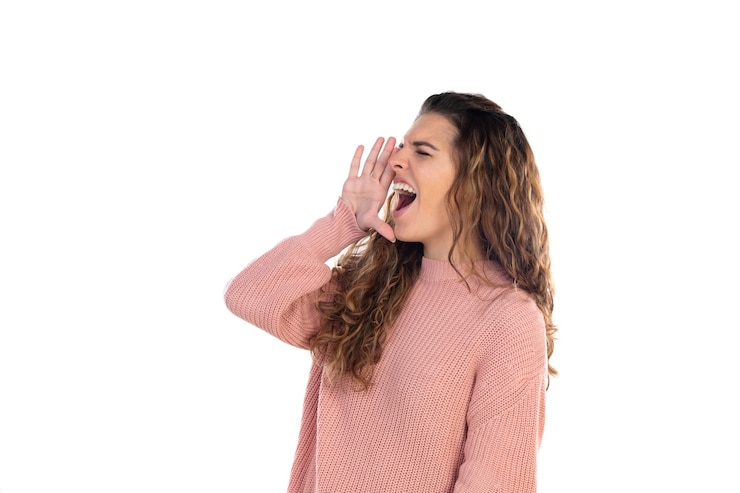 Fotografie beautiful middle aged woman with pink woolen sweater isolated on a white wall