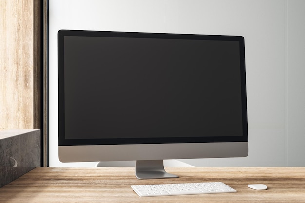black blank computer monitor on wooden table in loft style office