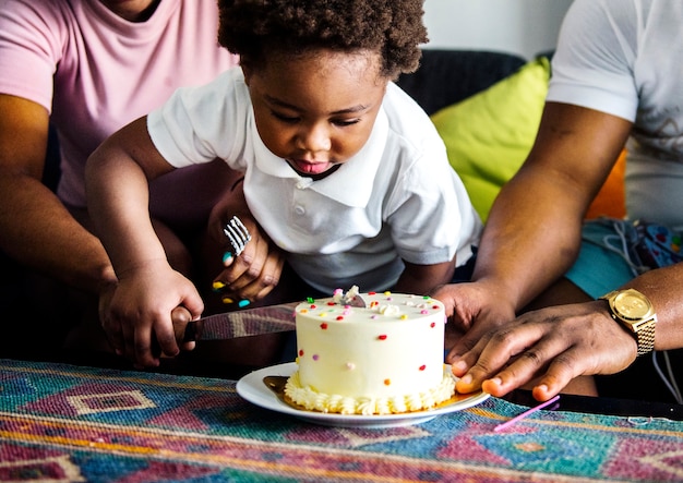 black family cutting birthday cake