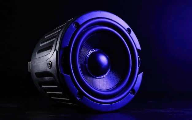 black loudspeaker on a black background in neon light