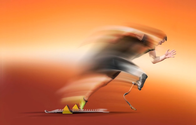 Blurred motion of man running against orange background