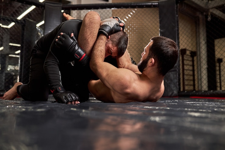 Fotografie boxers fighters fight without rules in the ring octagon. shirtless fighter makes strangling reception, going to win, athletic sporty male during mma