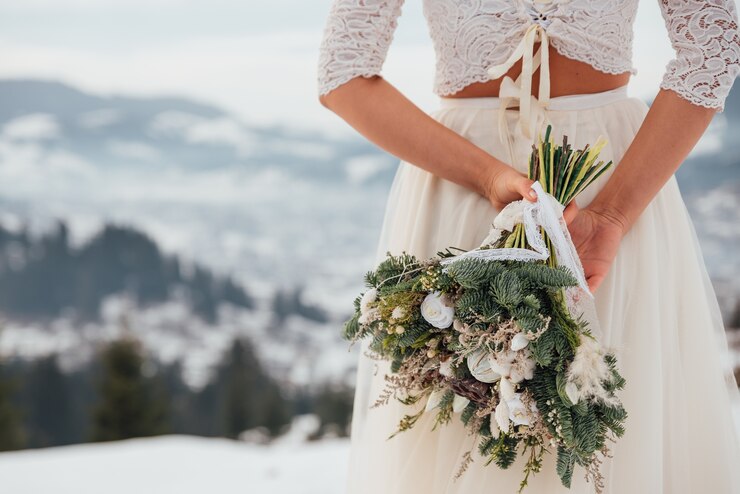 Fotografie bride in white wedding dress holding colorful flowers bouquet in hands