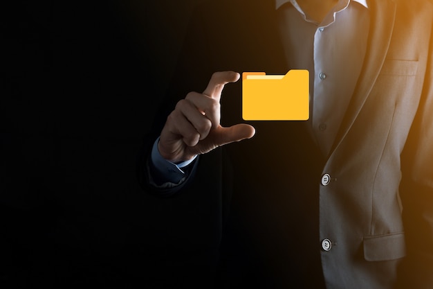 Businessman hold folder icon.Document Management System or DMS setup by IT consultant with modern computer are searching managing information and corporate files.Business processing,