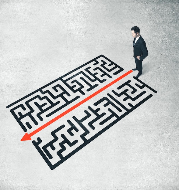 Businessman looking on red arrow