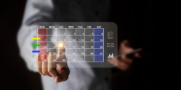 Businessman sets agenda on calendar as appointment planning concept