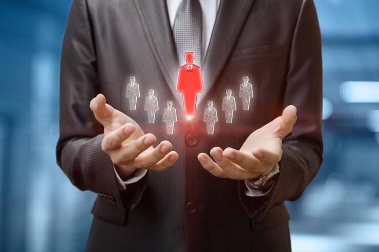 Fotografie businessman shows selected employee on blurred background