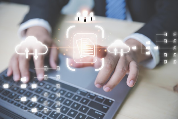 Businessman using a laptop to document management system DMS Management of documentation online and digital file storage system or software