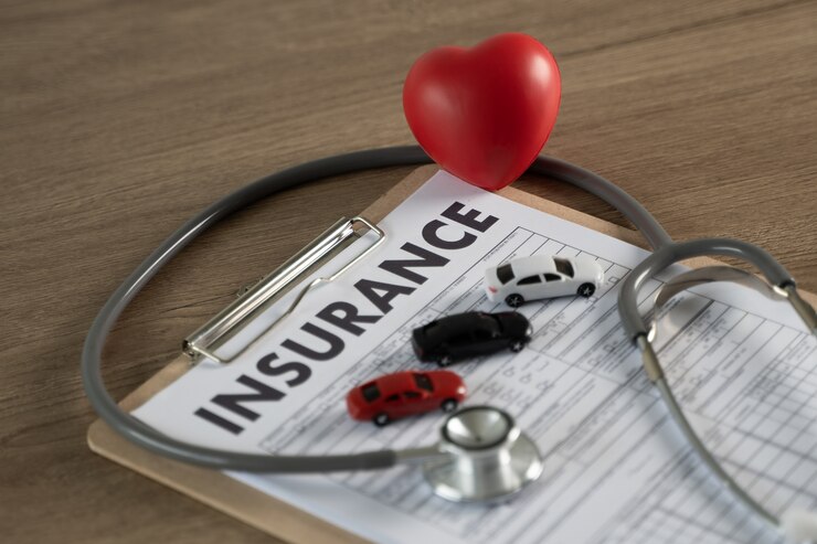 Fotografie car insurance in clipboard, stethoscope and heart