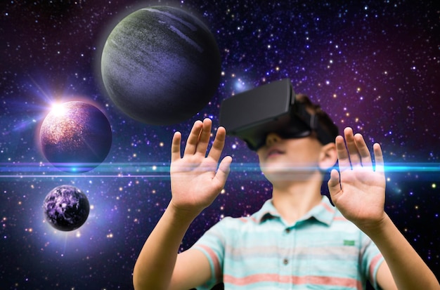childhood augmented reality technology and people concept boy with virtual headset or 3d glasses playing game outdoors at summer