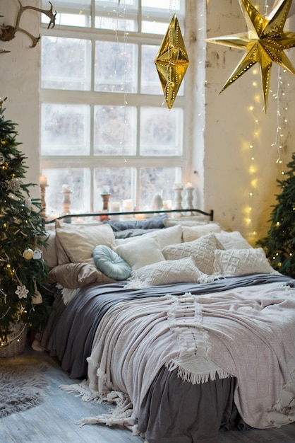 Christmas loft bedroom with big windows Christmas decorations Christmas trees and lights Loft boho interior with Christmas decor