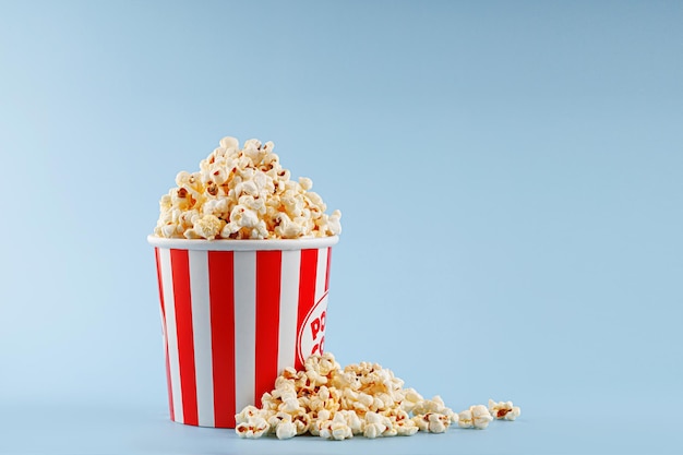 classic red striped popcorn cardboard cup on blue background
