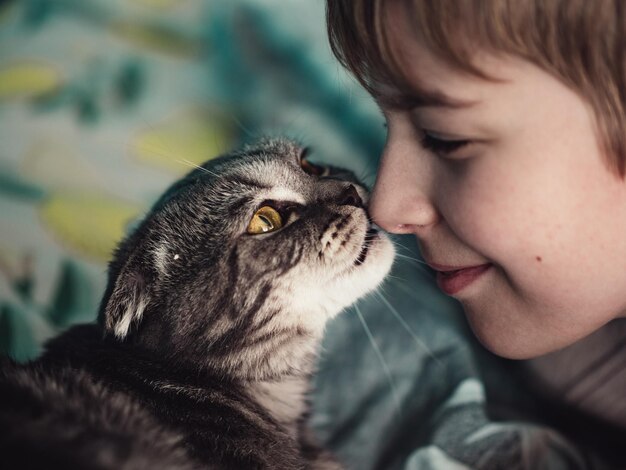 close-up of cat looking to the boy with love
