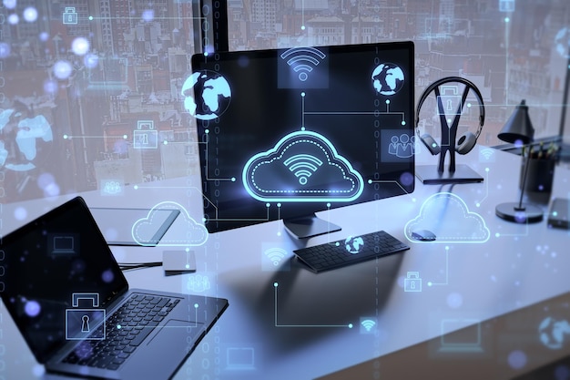 Close up of creative designer workplace with computer monitor laptop other objects and digital cloud computing hologram on blurry background Cloud data and service concept 3D Rendering