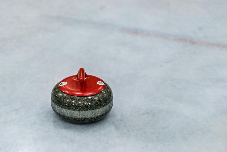 Fotografie close-up of curling stone on ice rink