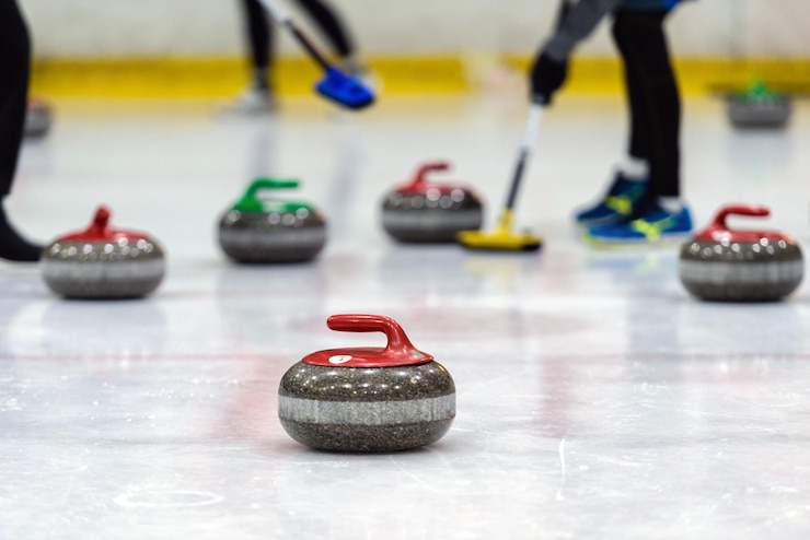 Fotografie close-up of curling stones on ice rink