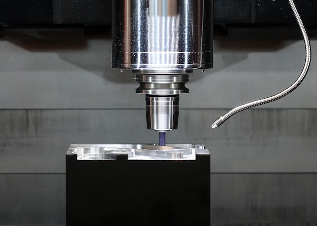 Close-up of drill machine on metal at factory