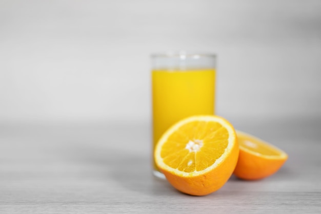 Close-up of fresh orange fruits and juice on table