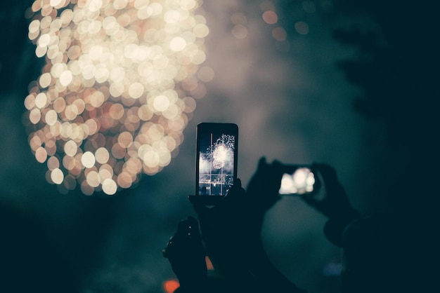 close-up of hand holding smart phone at night