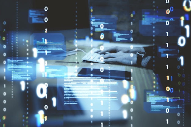 Close up of hands at desktop using computer keyboard with abstract coding binary code hologram on blurry background Artificial intelligence and development concept Double exposure