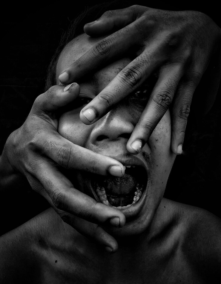 Fotografie close-up of hands holding baby hand over black background