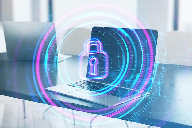 Close up of laptop on desktop with digital round polygonal padlock button on blurry background Secure safety and web protection concept Double exposure