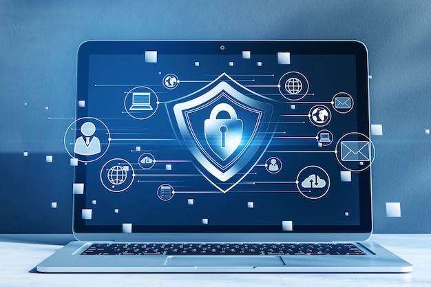 Close up of laptop with creative glowing padlock hologram on blurry background with various icons Safety and security concept