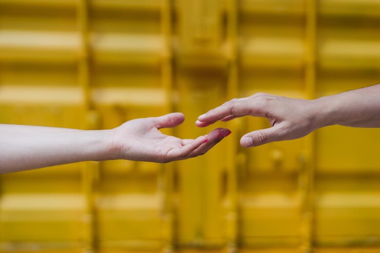 Fotografie close up of lesbian couple holding hands in front of yellow background love is love  lgbti concept