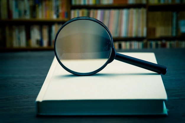 Close-up of magnifying glass on table
