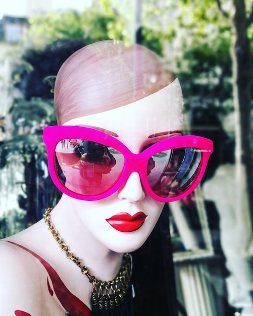 close-up of mannequin wearing pink eyeglasses